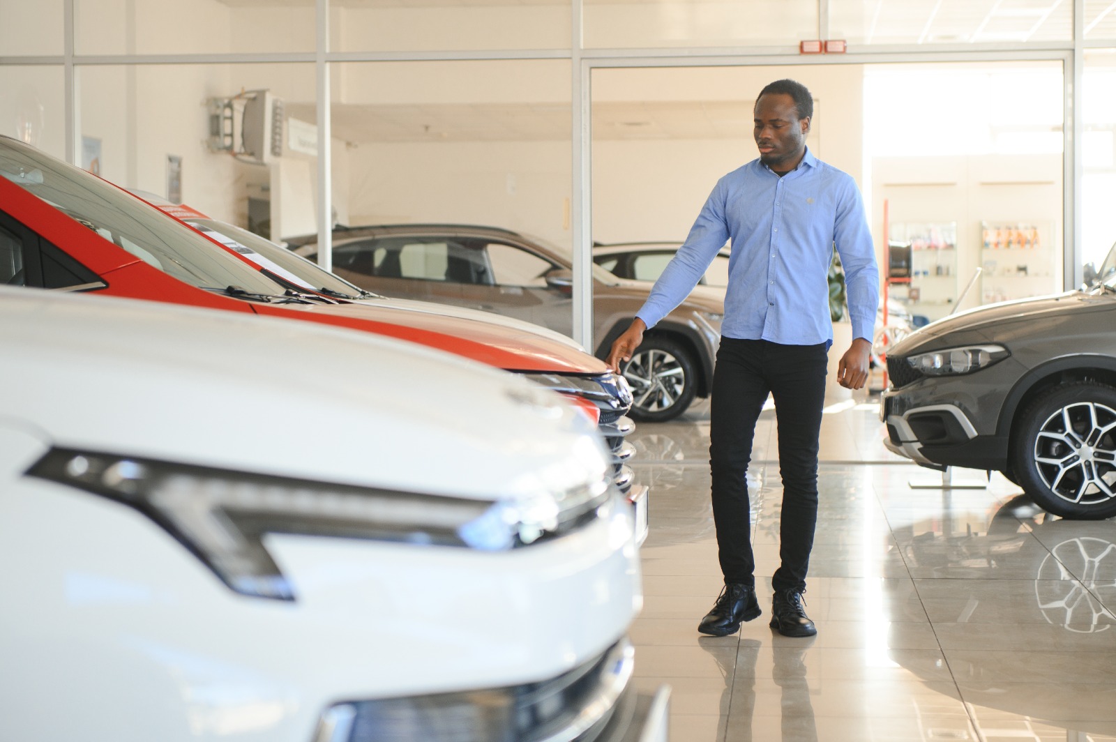 Clutch host and small business entrepreneur Michael J. smiling in front of cars